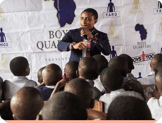 Man speaking to a group of boys at an event